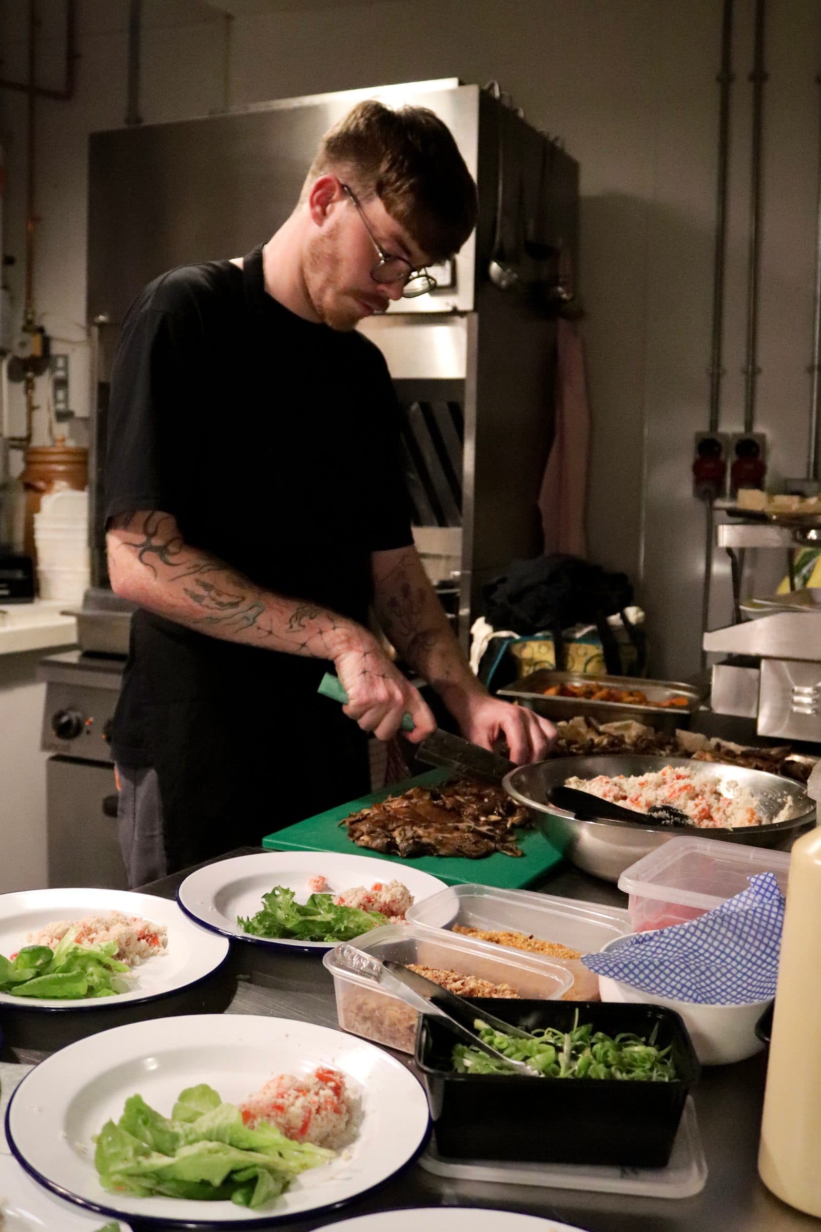 Chef seasoning the fried mushrooms. 