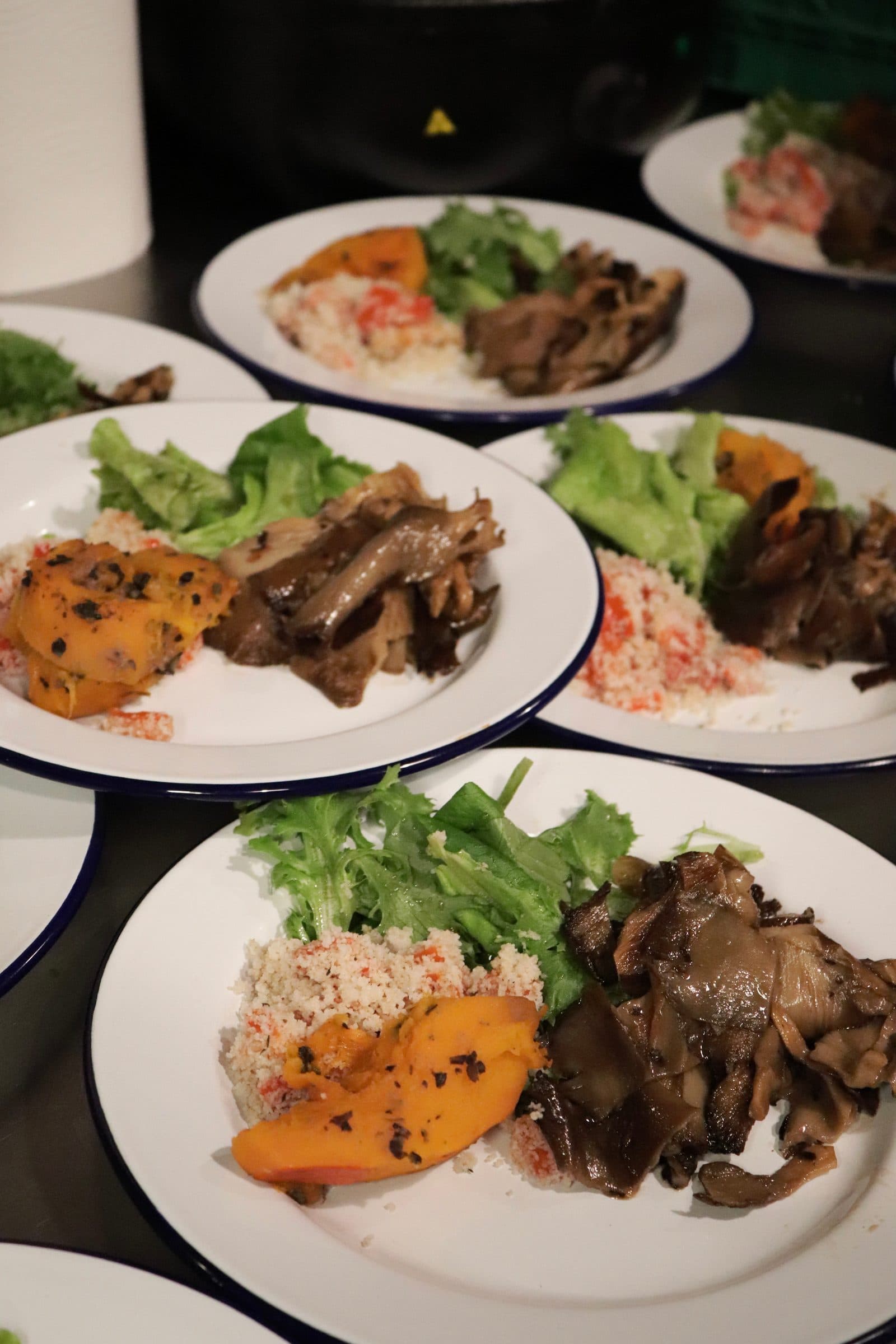 Two white plates with colourful vegan food.