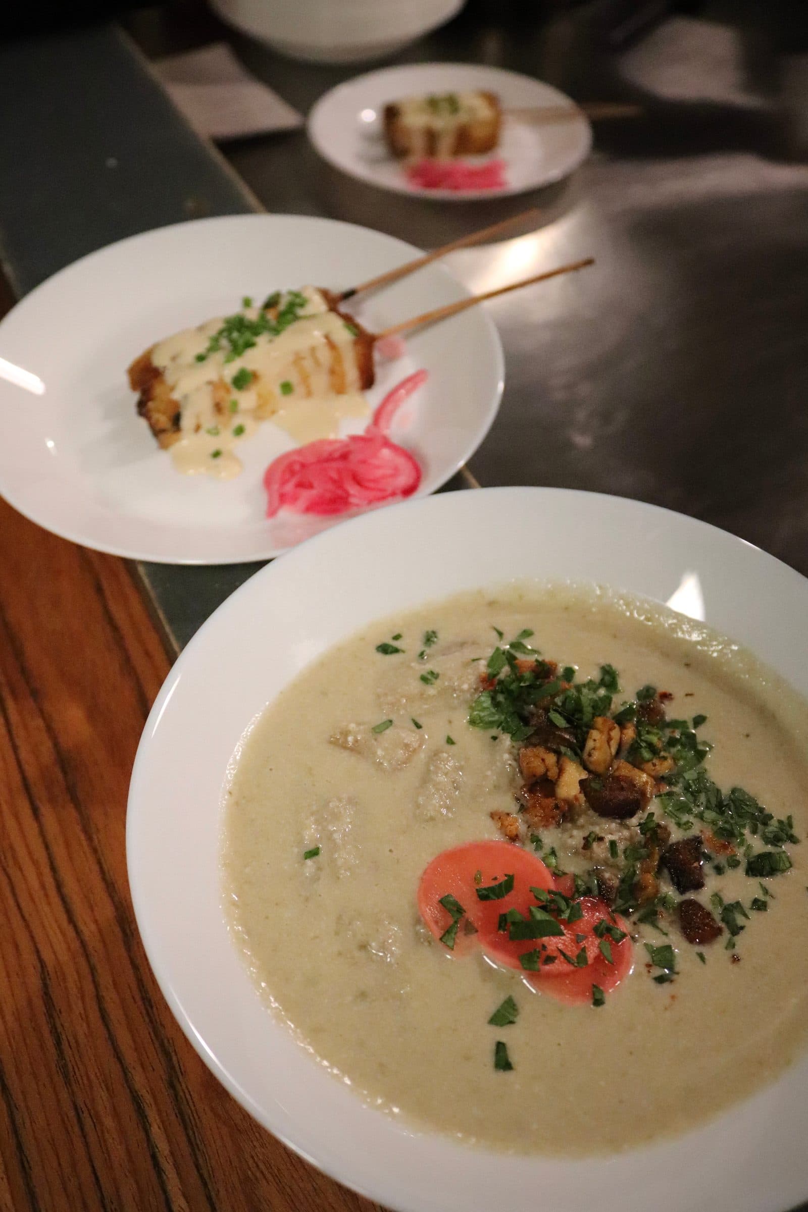 Two white plates with colourful vegan food.